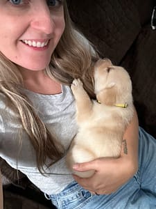 Katie holding 28 day old yellow lab sleeping