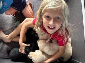 granddaughter holding five 28 day old puppies at once